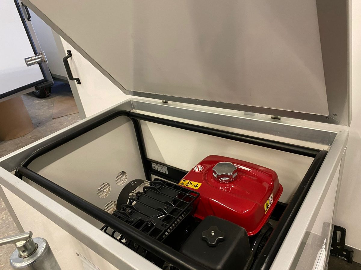 Generator in a sealed compartment of a white trailer