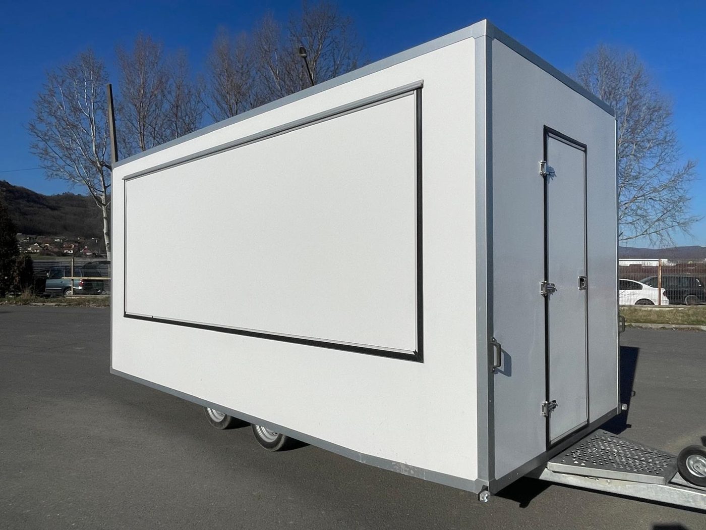 White closed trailer on the road